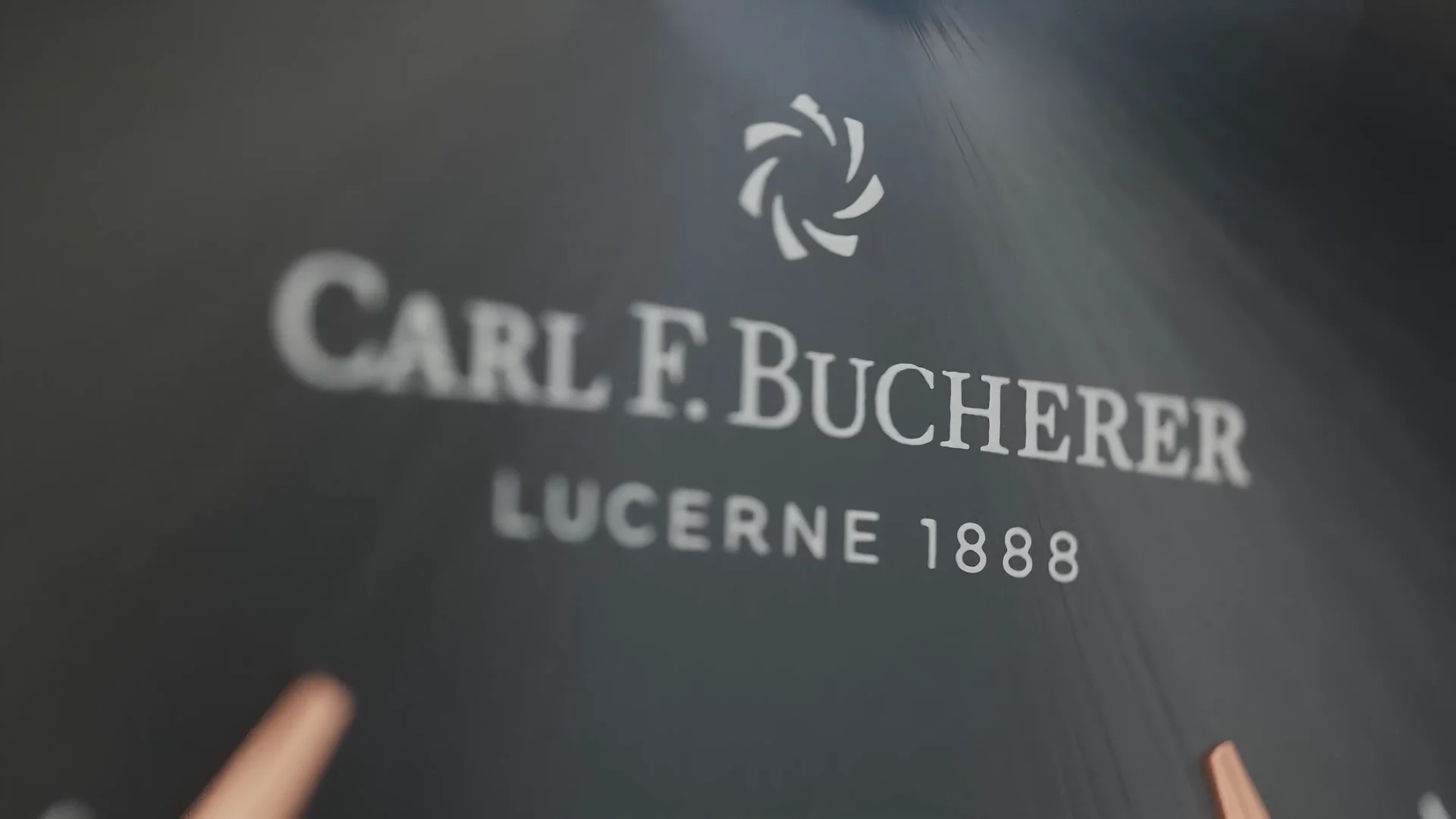 we see the lettering Carl F Bucherer, Lucerne 1888 on a black background