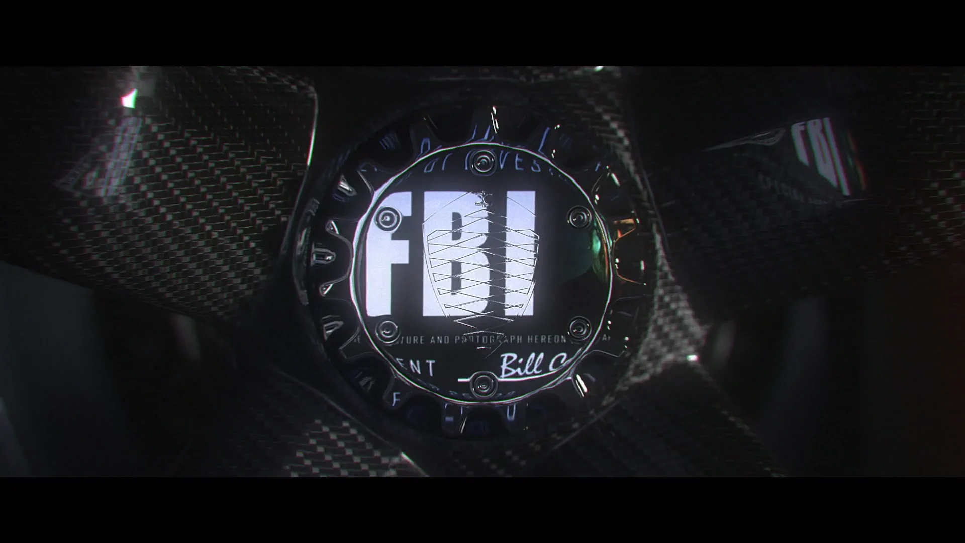 The letters FBI as a reflection or projection on a black surface