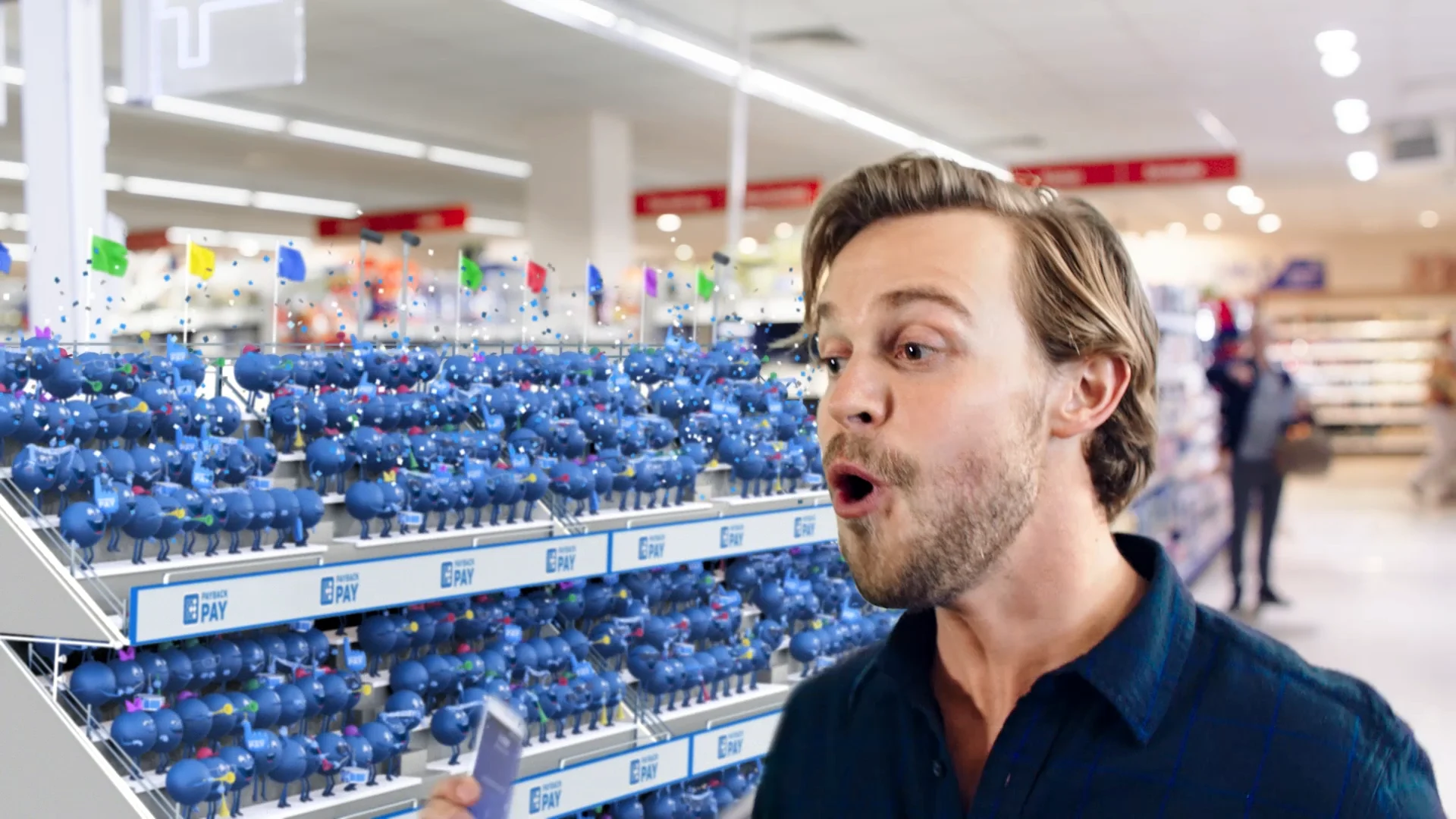 a man in a supermarket in front of a grandstand filled up with litte blue payback point 3d characters who are cheering at him