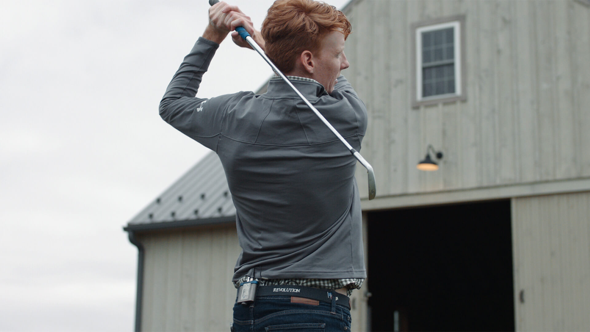 Alex Kane taking a golf swing.