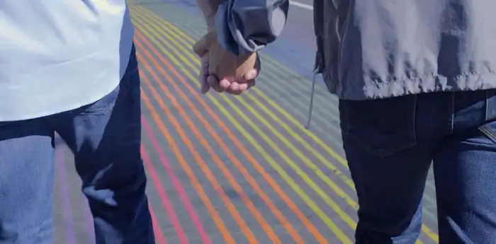 Two men holding hands