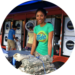 A member of Tide Loads of Hope programme helping with laundry