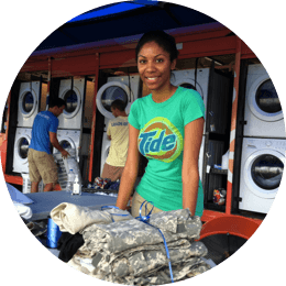A member of Tide Loads of Hope programme helping with laundry