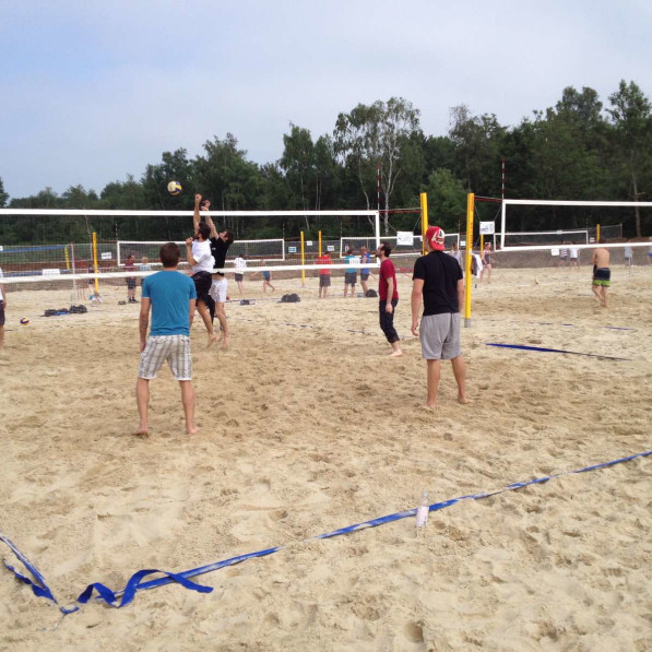 Young people playing beach volley