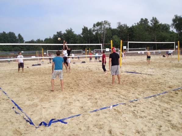 Young people playing beach volley
