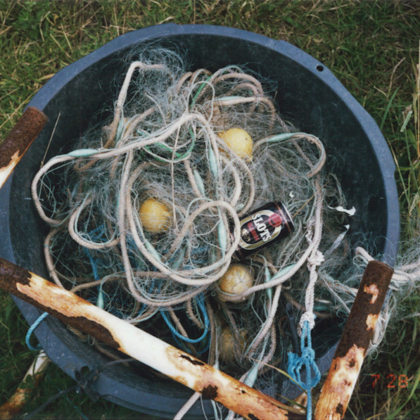 Fishnet and a can of beer in a bucket