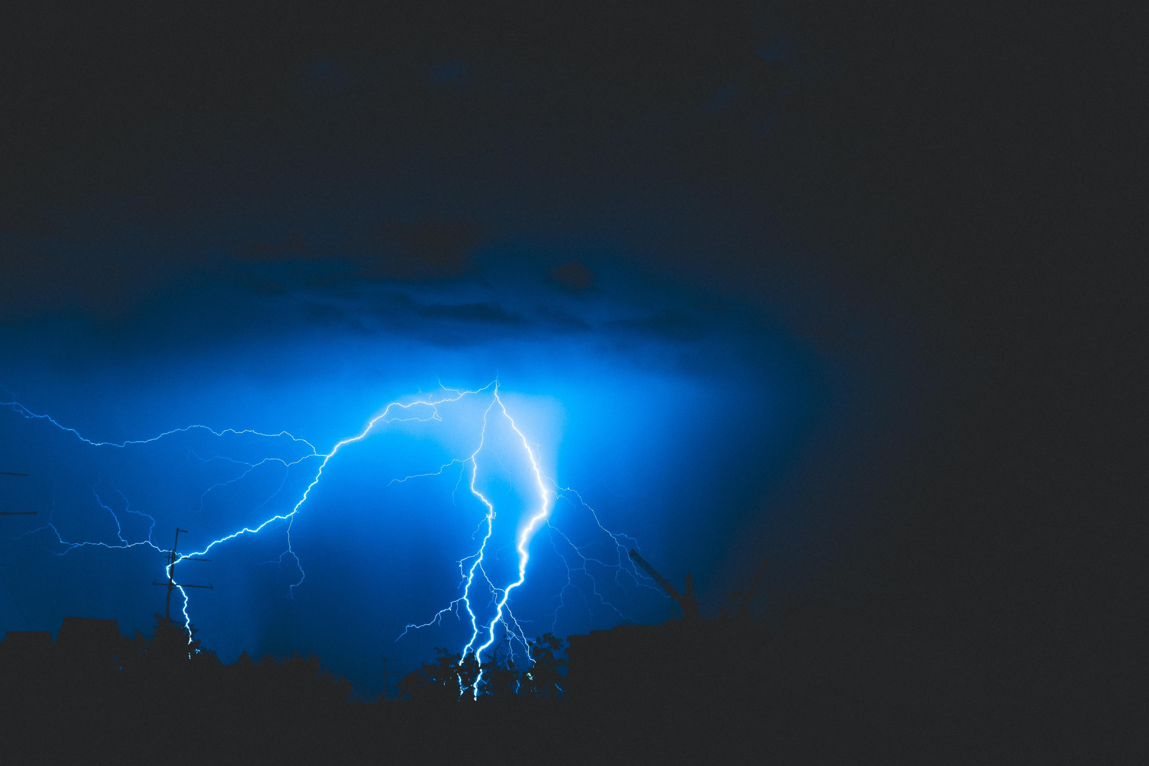 A picture of lightning striking from the sky to the ground by Alex Dukhanov on Unsplash