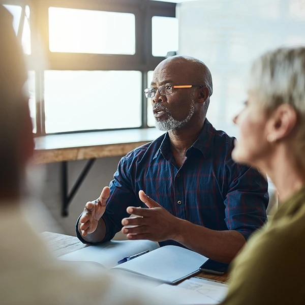 Man talking at a meeting using hand gestures