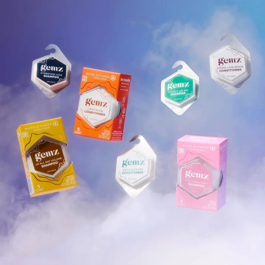 A variety of Gemz hair care products, including shampoos and conditioners in both individual pods and boxes.