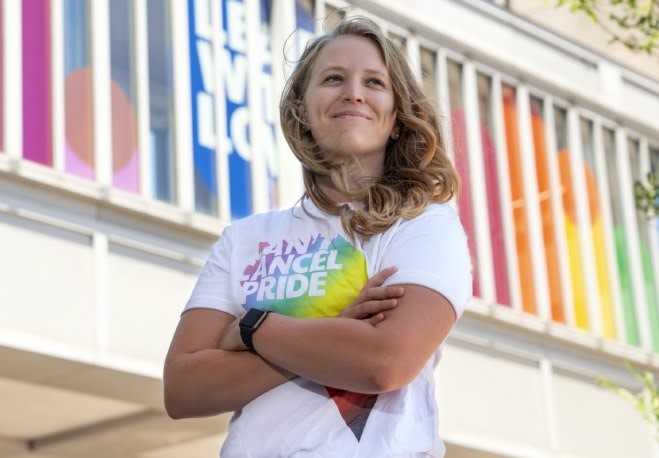 Person in Can’t Cancel Pride t-shirt at Cincinnati GO which is decorated with a rainbow and the words “Lead with Love”. 