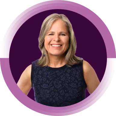 Shelly McNamara, Chief Equity and Inclusion Officer, is smiling directly towards the camera. She has short blonde hair and is wearing a black shirt.