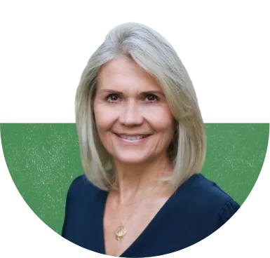 Chief Sustainability Officer Virginie Helias wearing a blue V-neck dress and gold necklace