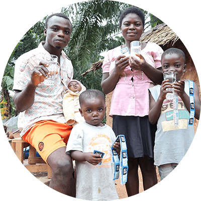 Family holding P&G purified water and purifying packets