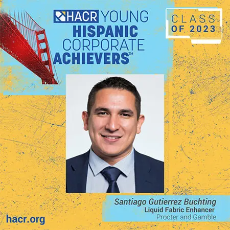A headshot of a Hispanic male with short dark hair is centered in a blue and yellow illustrated graphic for the HACR Young Hispanic Corporate Achievers program class of 2023.