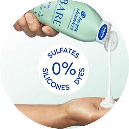 A hand squeezes a light green Head & Shoulders shampoo bottle while another hand catches the white liquid as it pours out of the spout. Blue text reads, "0% sulfates, silicones, dyes."