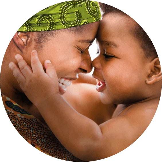 A smiling mom and baby embrace and touch noses