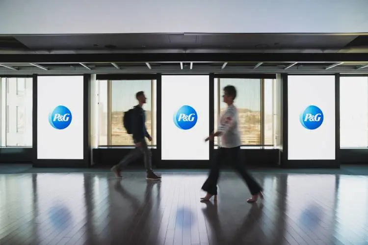 Silhouettes of P&G employees walking in front of windows.
