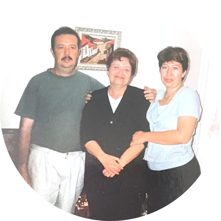 Two women and a man posing for photo.