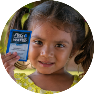 Child holding P&G Purifier of Water packet