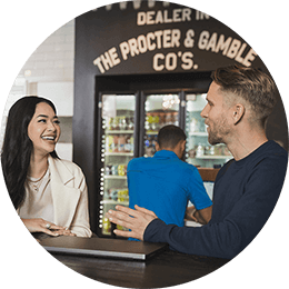 A man and woman sit at a table. They are laughing and talking.