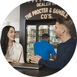 A man and woman sit at a table. They are laughing and talking.