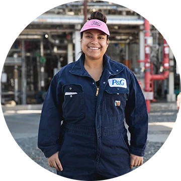 Woman in front of a manufacturing facility