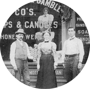 Historic photograph of people outside the 1880s Bartlett Store with “Highest Grade, Honest Weight” signage