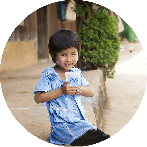 Child smiling and drinking purified water