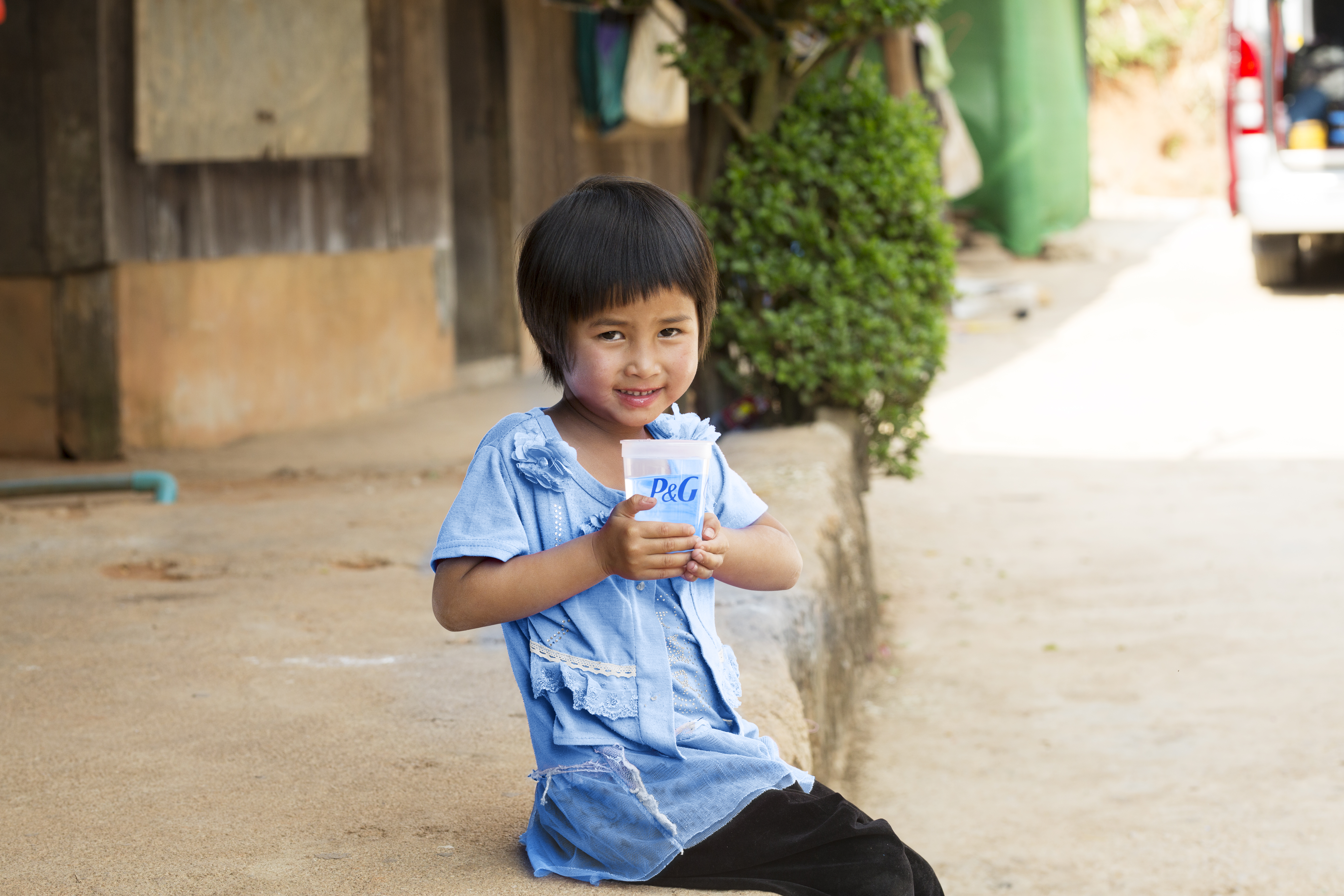 Child holding a glass of clean water