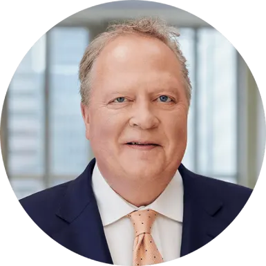 P&G Chairman of the Board, President and Chief Executive Officer Jon R. Moeller wearing a navy blue suit and red tie with stripes.