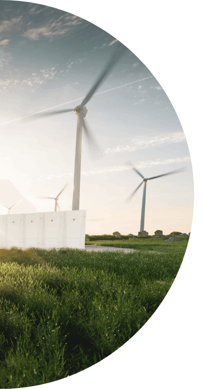 Several wind turbines spin in a green field