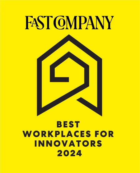 A black illustrated pentagon-shaped logo. Black text says “Fast company. Best workplaces for innovators 2024.” And a bright yellow background.