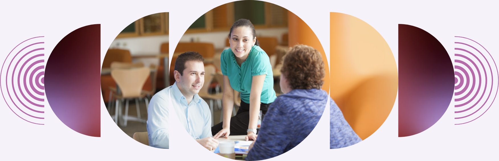 Two women and a man seated at an office table working together