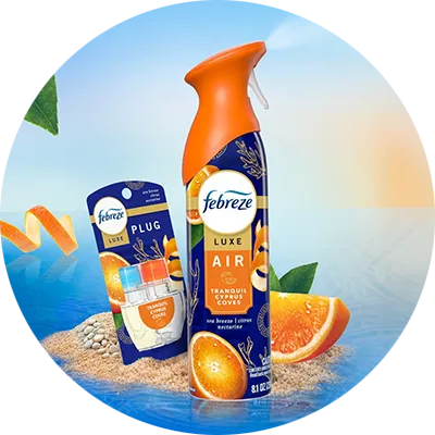 Febreze Luxe Air spray and Plug refill, Tranquil Cyprus Coves scent, on a beach with citrus.