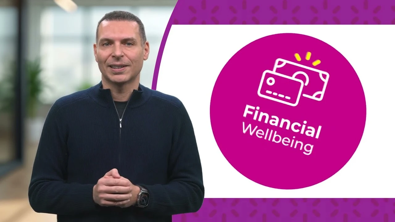 Person standing indoors beside a circular graphic reading “Financial Wellbeing”.
