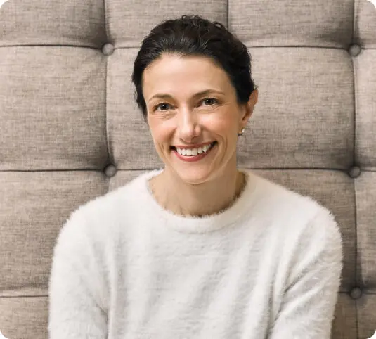 Alex Keith, Chief Executive Officer - P&G Beauty Executive Sponsor - LGBTQ+ Equality Executive Sponsor - Corporate Sustainability, is smiling towards the camera and wearing a white jumper.