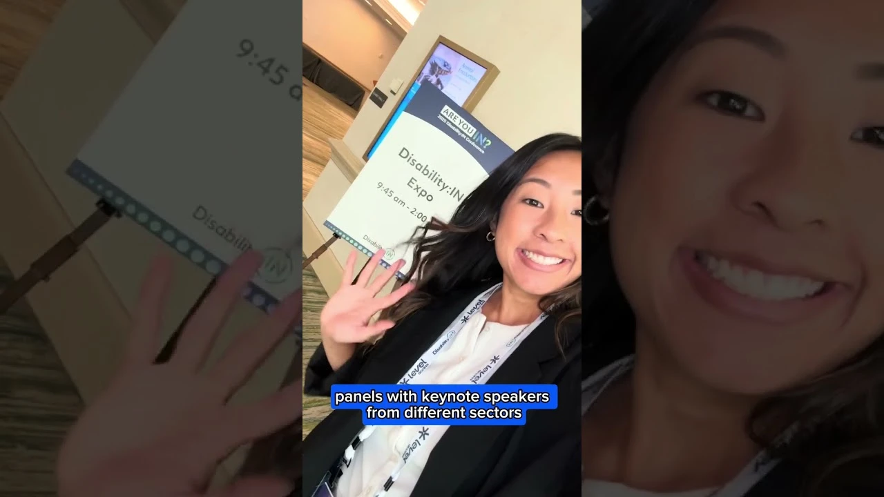 A young woman with long dark hair in a white shirt and black jacket.