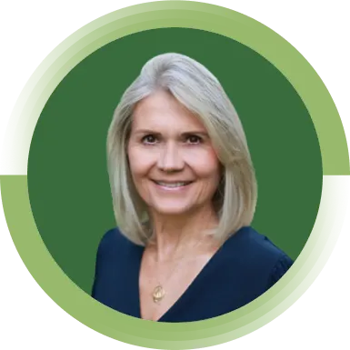 Virginie Helias, Chief Sustainability Officer of P&G smiles at the camera. She has short blonde hair and is wearing a blue blouse.