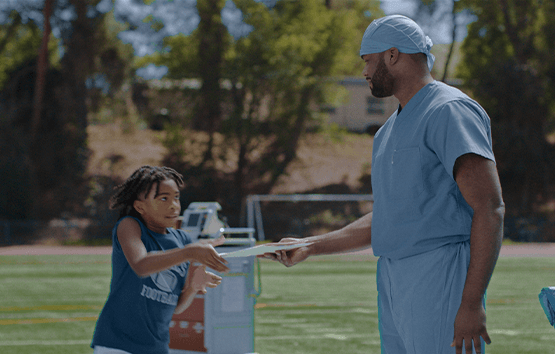 Boy and doctor on the football field