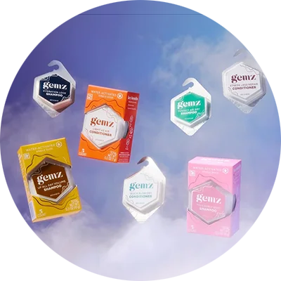 A variety of Gemz hair care products, including shampoos and conditioners in both individual pods and boxes.