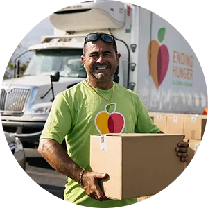 A Feeding America volunteer distributes food donations to alleviate food insecurity.