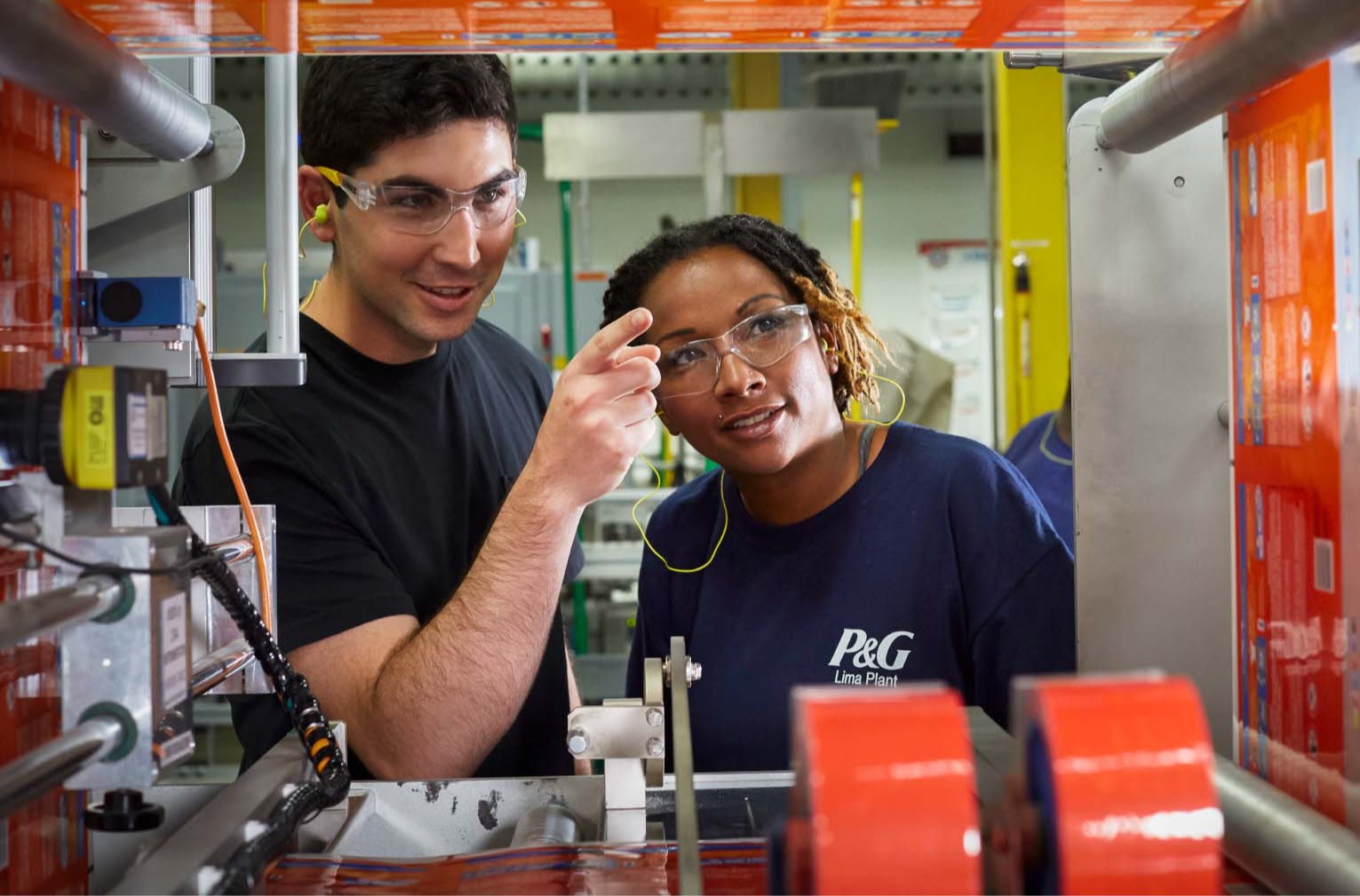 Two employees talking together in a manufacturing environment