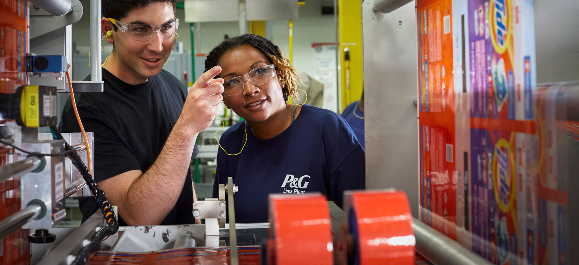 Two employees talking together in a manufacturing environment