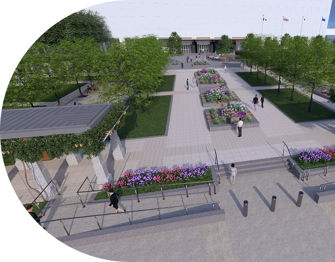 Aerial view of a landscaped public plaza with flowers, trees, pathways, and people walking in the area