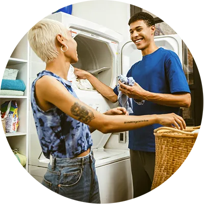 A woman and man doing laundry at home.