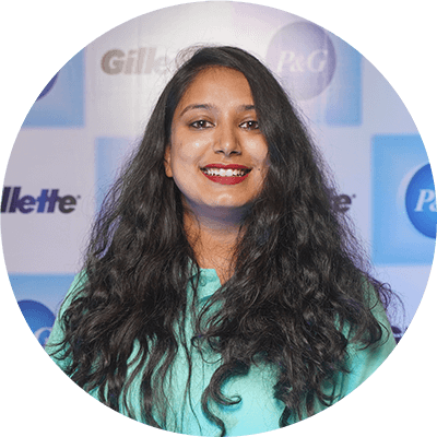 Headshot of smiling Indian woman with long dark hair.