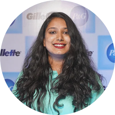 Headshot of smiling Indian woman with long dark hair.