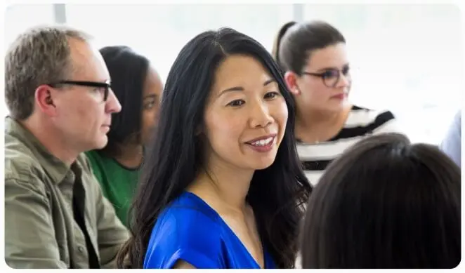 Four people in a group are sitting together and talking.