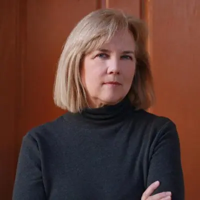 Kathy Guillermo looking towards the camera, wearing a dark turtleneck.