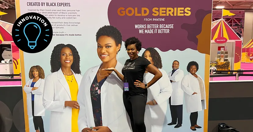 Ashley standing in front of the Gold Series from Pantene poster